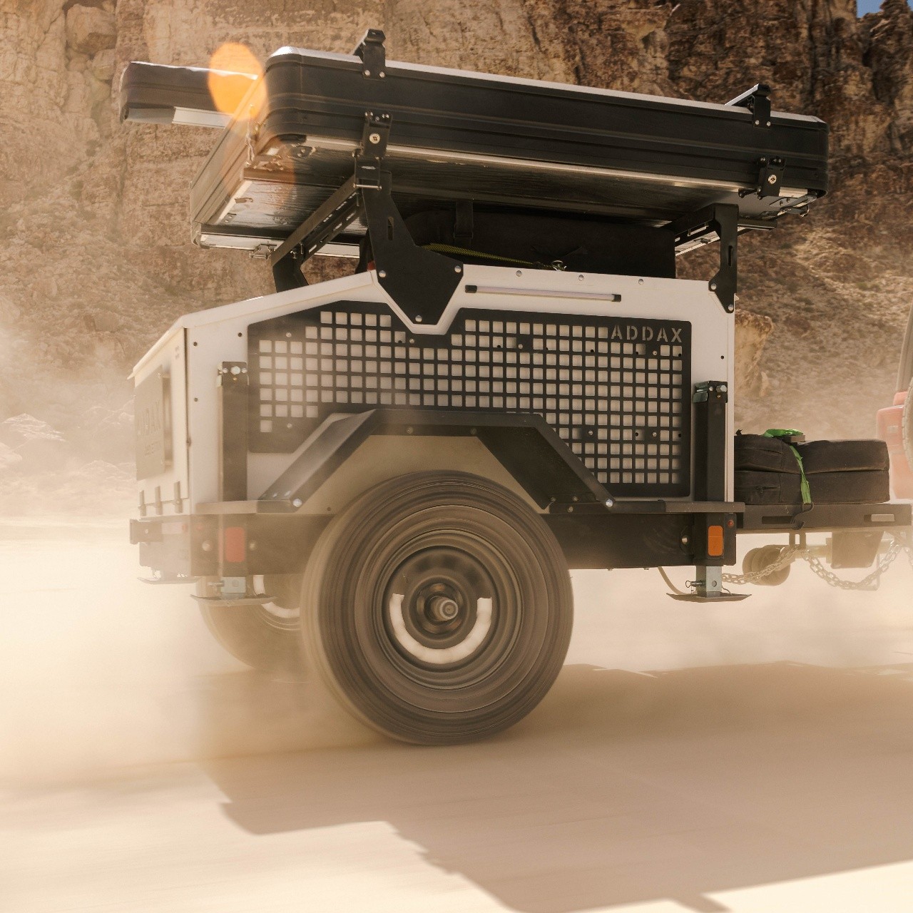 ADDAX all-terrain trailer kicking up dust in the desert