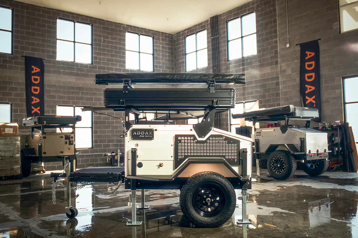 ADDAX Basecamp trailer with its 270-degree awning deployed at a desert camp