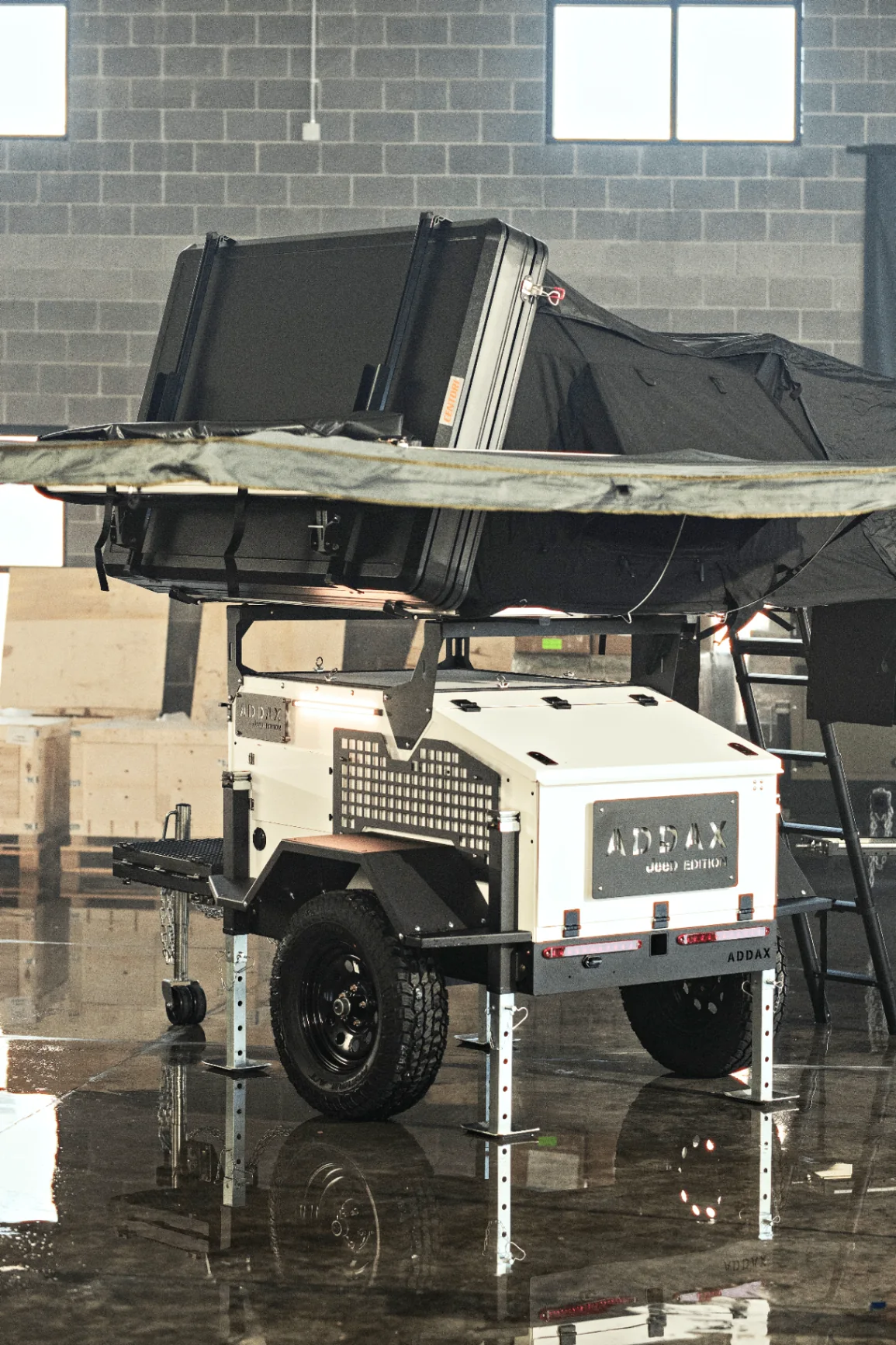 Rooftop tent opening on an ADDAX Basecamp V3 trailer at golden hour